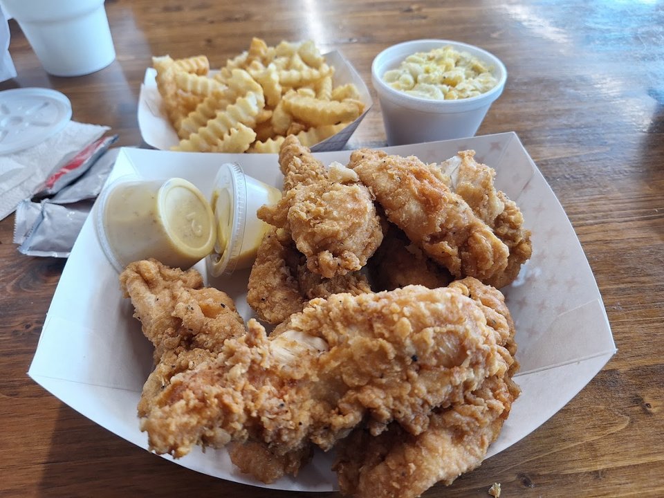 Chicken meal served with okra and coleslaw.